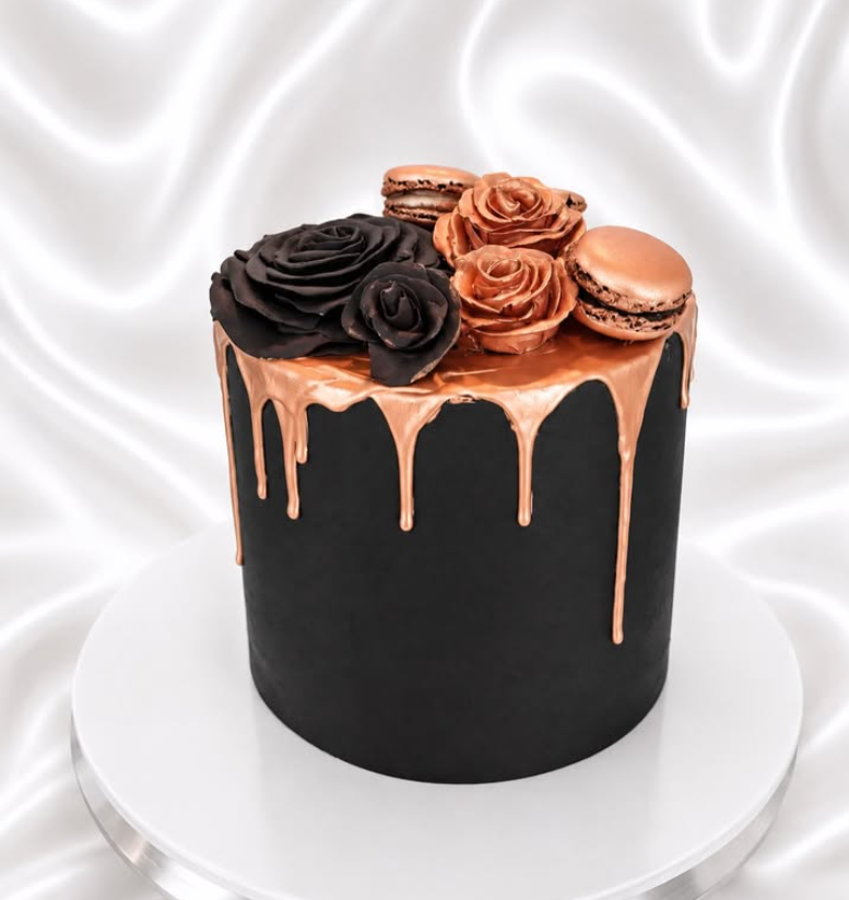 Matte black celebration cake with poured rose gold, chocolate roses and macarons